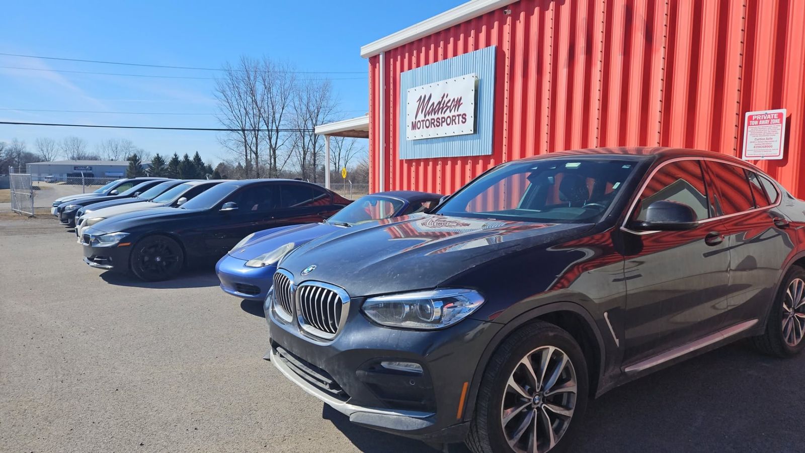 BMW X4 and Porsche outside the shop