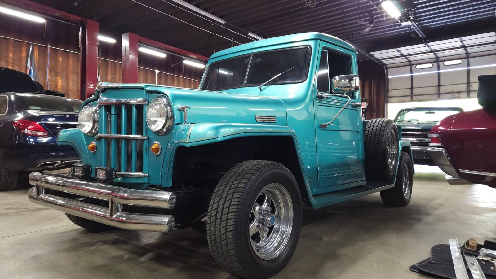 Restored turquoise Willys pickup in the shop