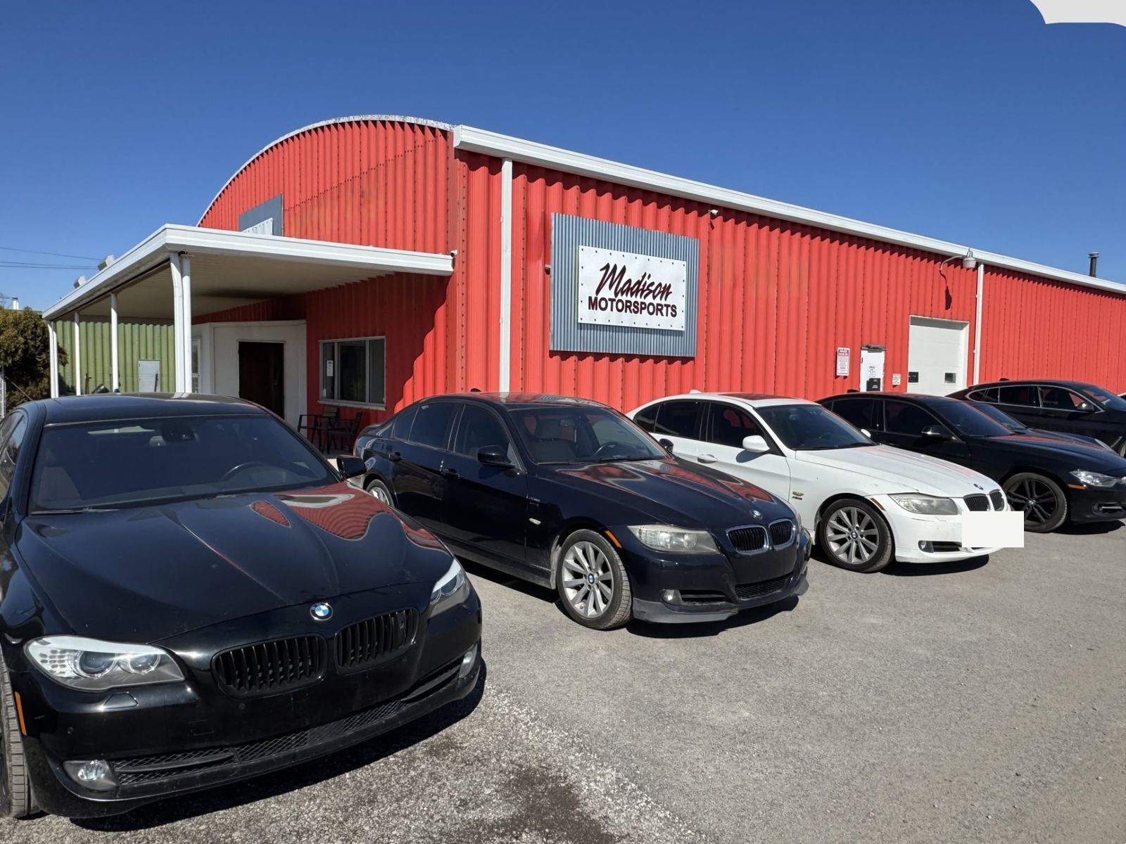 BMWs parked in front of the shop