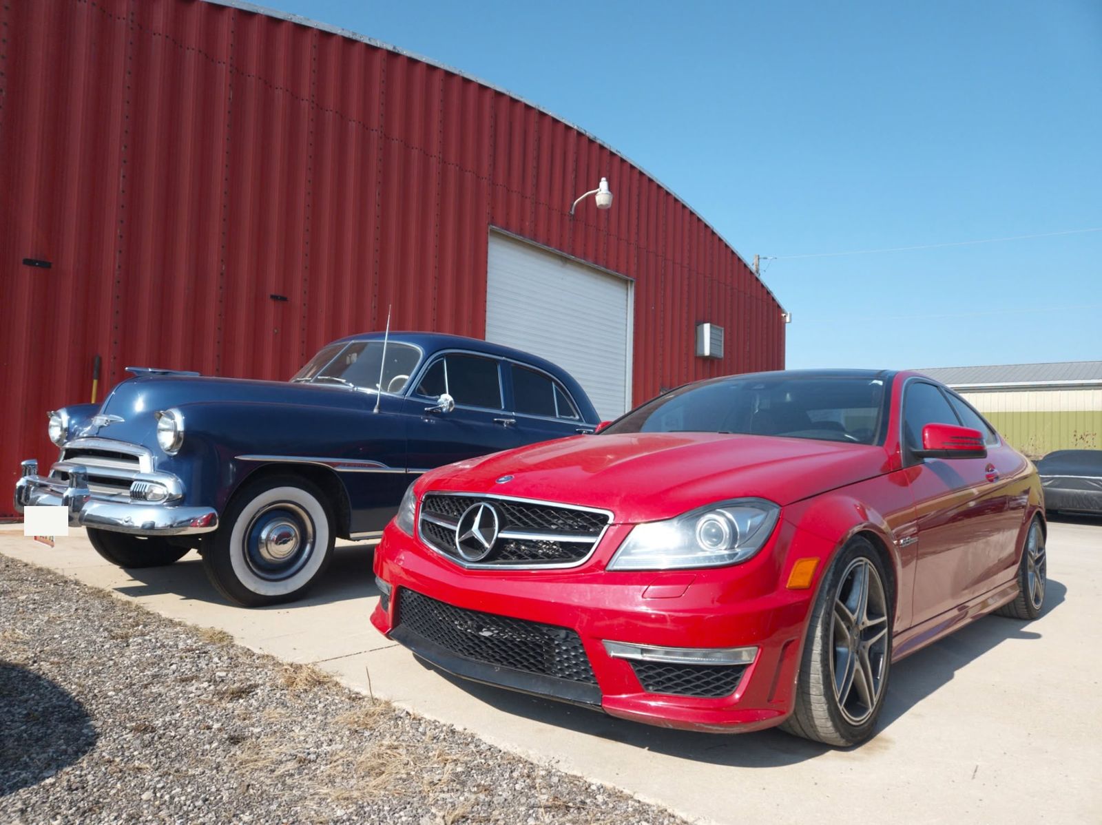 Classic Chevrolet next to a Mercedes-AMG C63